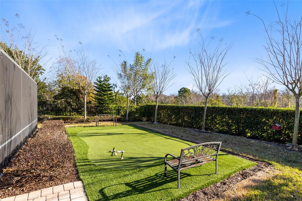 9374 Reymont Street Orlando, FL 32827 - Photo 49 of 54 a view of a swimming pool with a patio and a yard