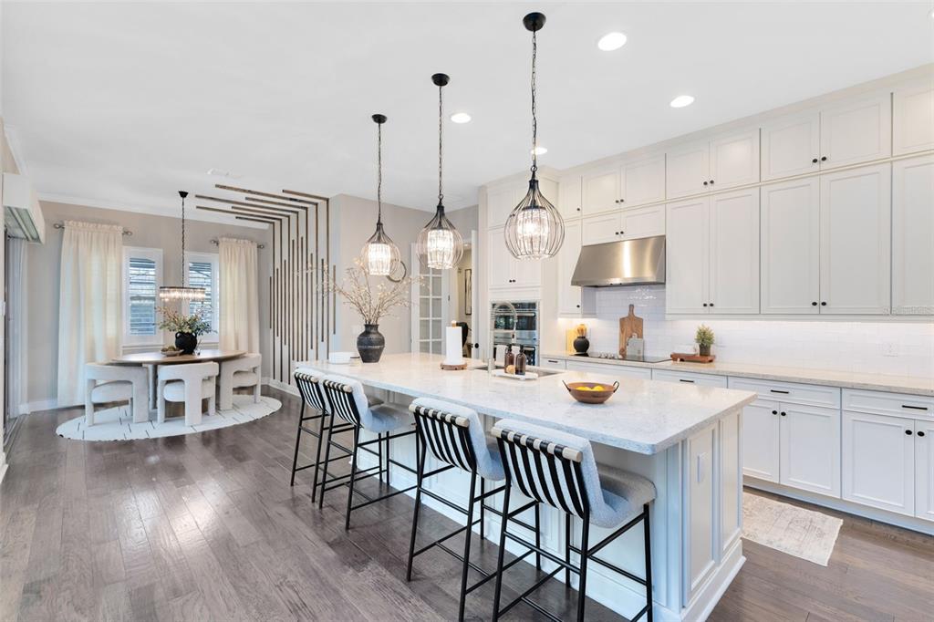 9374 Reymont Street Orlando, FL 32827 - Photo 8 of 54 a open kitchen with stainless steel appliances granite countertop a stove a kitchen island a table and chairs in it