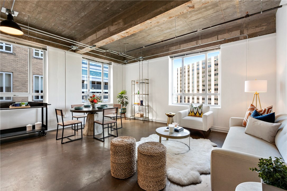 710 Colorado Street, Unit 9A Austin, TX 78701 - Photo 1 of 1 a living room with furniture and a large window