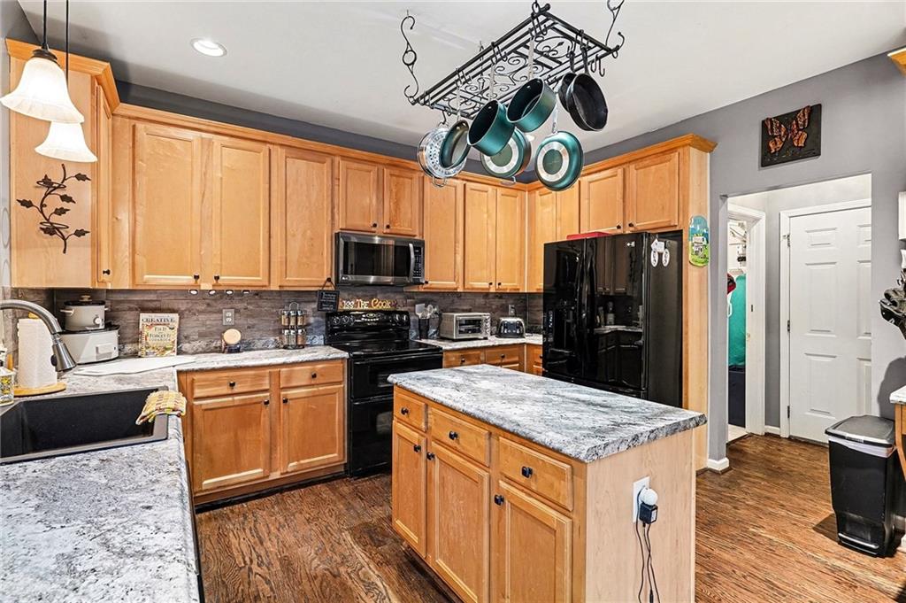 174 Senators Ridge Drive Dallas, GA 30132 - Photo 11 of 26 a kitchen with stainless steel appliances granite countertop a sink stove and refrigerator