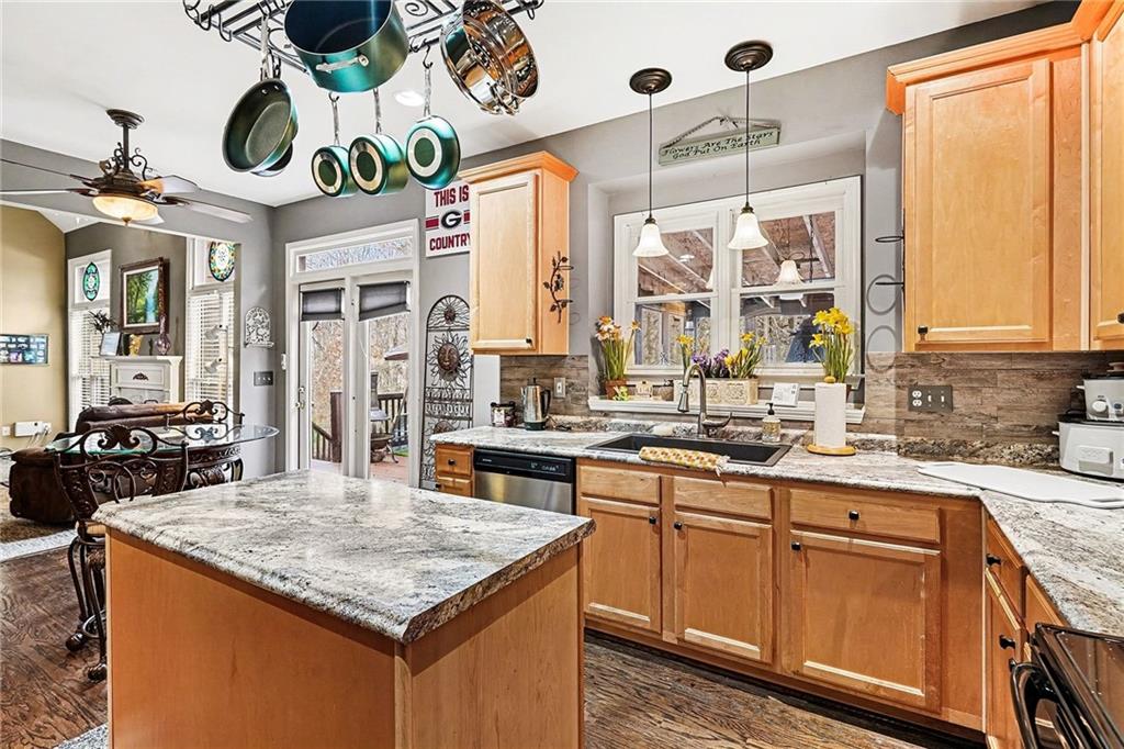 174 Senators Ridge Drive Dallas, GA 30132 - Photo 12 of 26 a kitchen with kitchen island granite countertop a stove a sink and a refrigerator