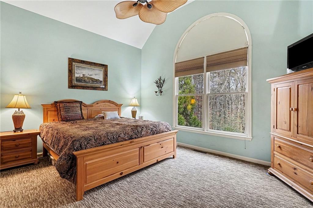 174 Senators Ridge Drive Dallas, GA 30132 - Photo 14 of 26 a spacious bedroom with a bed and a flat screen tv