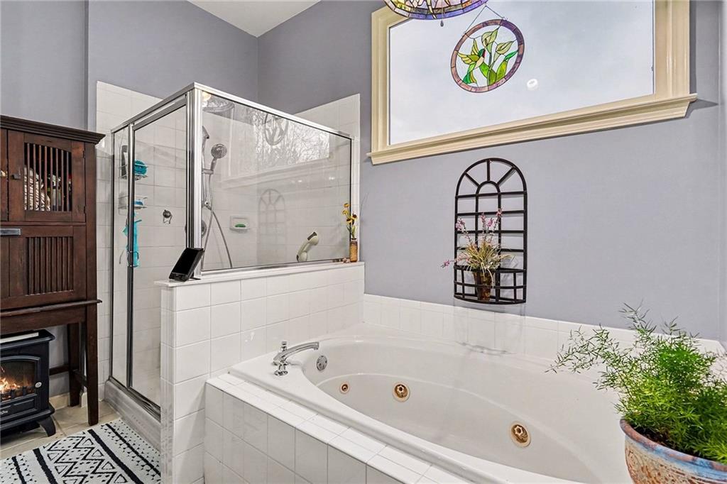 174 Senators Ridge Drive Dallas, GA 30132 - Photo 17 of 26 a bathroom with a bathtub a sink and a shower