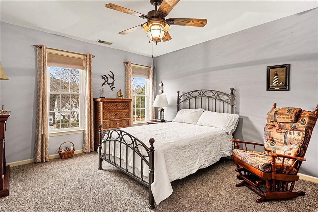 174 Senators Ridge Drive Dallas, GA 30132 - Photo 18 of 26 a bedroom with a bed and a chandelier