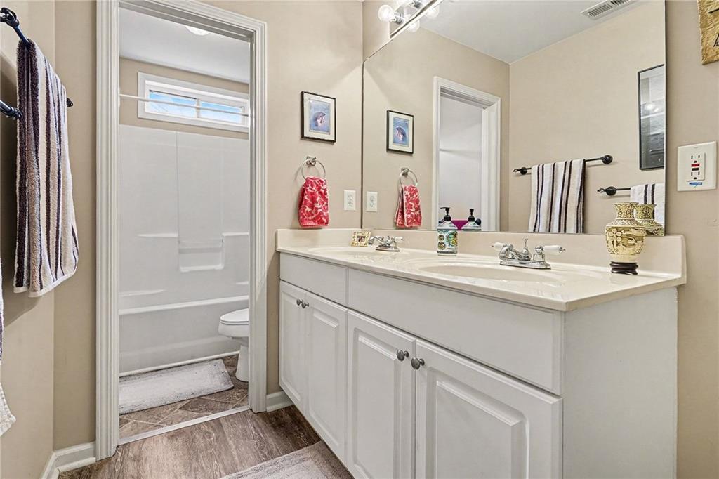 174 Senators Ridge Drive Dallas, GA 30132 - Photo 23 of 26 a bathroom with a sink vanity tub and a mirror
