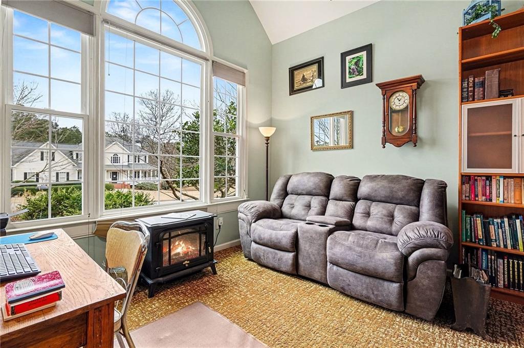 174 Senators Ridge Drive Dallas, GA 30132 - Photo 6 of 26 a living room with furniture a bookshelf and a window