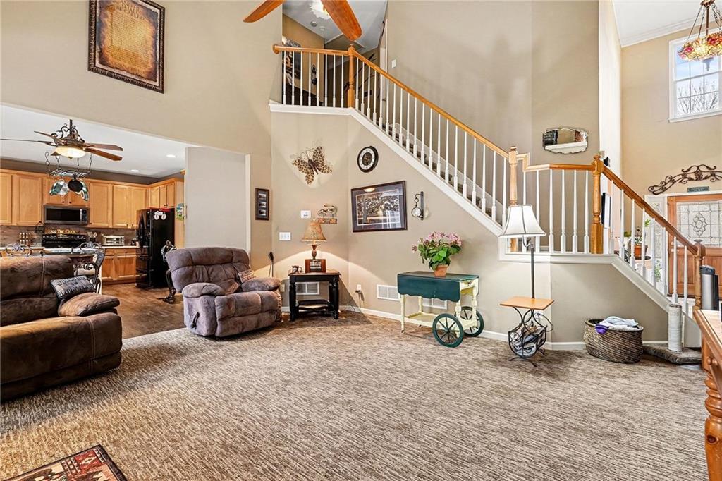 174 Senators Ridge Drive Dallas, GA 30132 - Photo 8 of 26 a living room with furniture and a chandelier