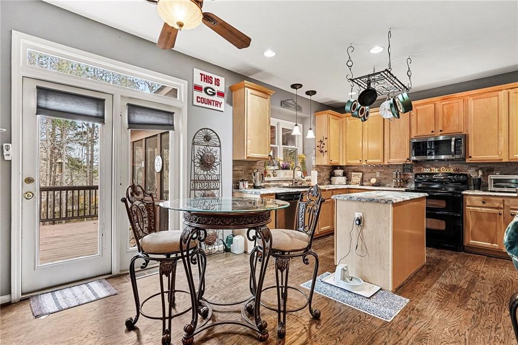 174 Senators Ridge Drive Dallas, GA 30132 - Photo 10 of 26 a kitchen with stainless steel appliances granite countertop a stove a sink dishwasher and a refrigerator with wooden floor