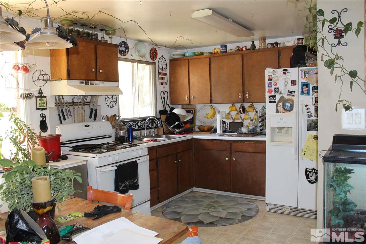 9190 Fremont Way Reno, NV 89506 - Photo 2 of 8 a kitchen with stainless steel appliances granite countertop a stove a sink and a refrigerator