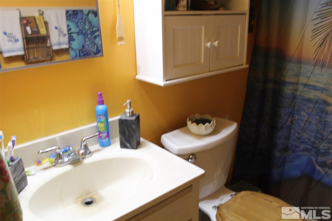 9190 Fremont Way Reno, NV 89506 - Photo 4 of 8 a bathroom with a sink and a mirror