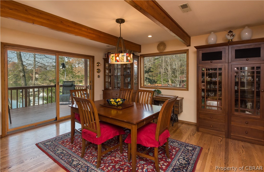 297 Cove Colony Road Lancaster, VA 22503 - Photo 15 of 50 a view of a dining room with furniture window and wooden floor