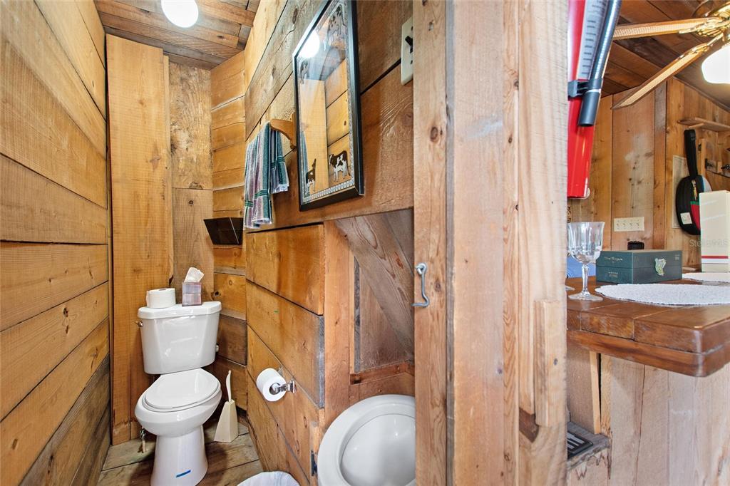 3641 Turtle Mound Road Melbourne, FL 32934 - Photo 48 of 77 a bathroom with a toilet and a shower curtain