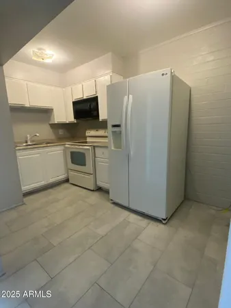 a kitchen with stainless steel appliances a refrigerator and a stove top oven