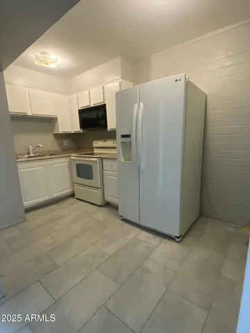 a kitchen with stainless steel appliances a refrigerator and a stove top oven