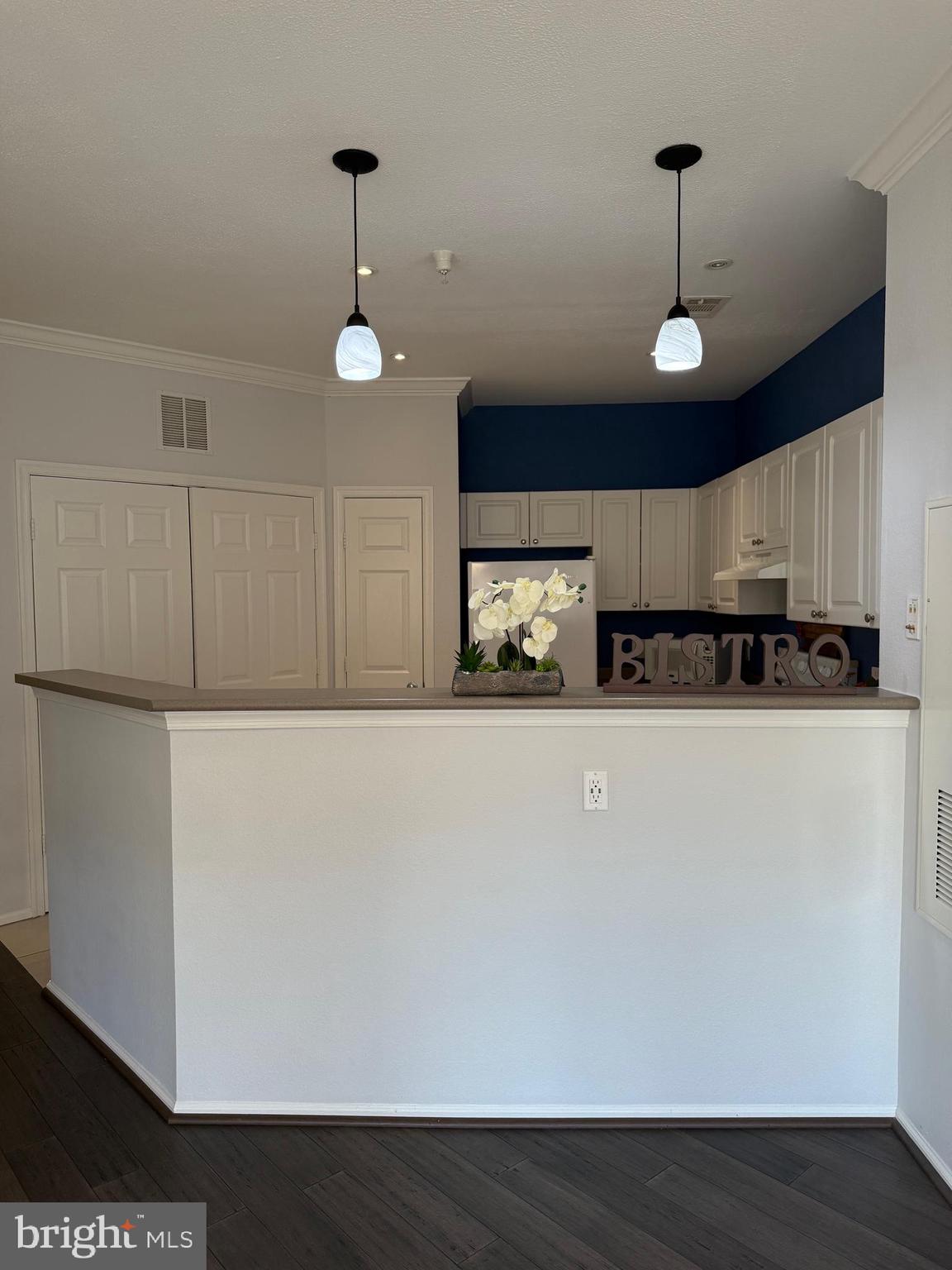 3009 Nicosh Circle, Unit 4302 Falls Church, VA 22042 - Photo 12 of 32 a kitchen with stainless steel appliances a refrigerator and a wooden floor