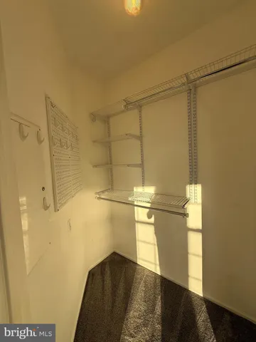 a view of empty room with wooden floor and cabinet