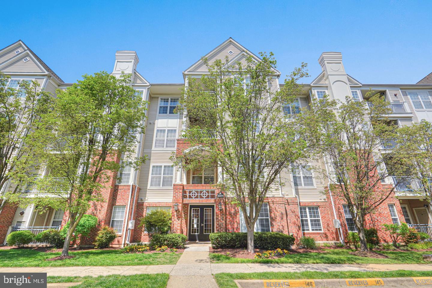 3009 Nicosh Circle, Unit 4302 Falls Church, VA 22042 - Photo 2 of 32 front view of a residential apartment building with a yard