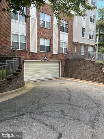 a view of a street with a house in the background