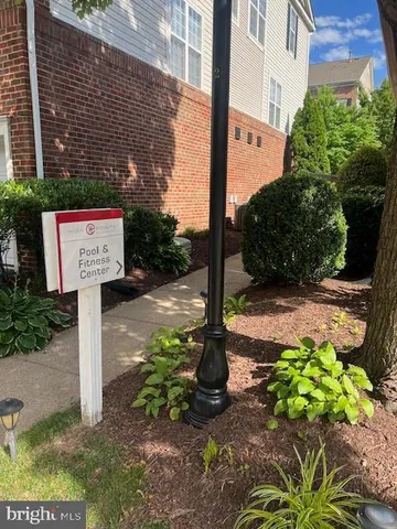 a view of a swimming pool with lawn chairs under an umbrella