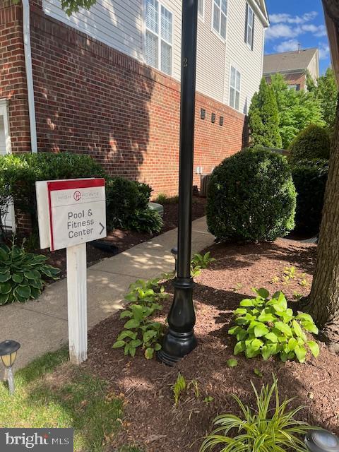 3009 Nicosh Circle, Unit 4302 Falls Church, VA 22042 - Photo 28 of 32 a sign board with a house and yard in the back