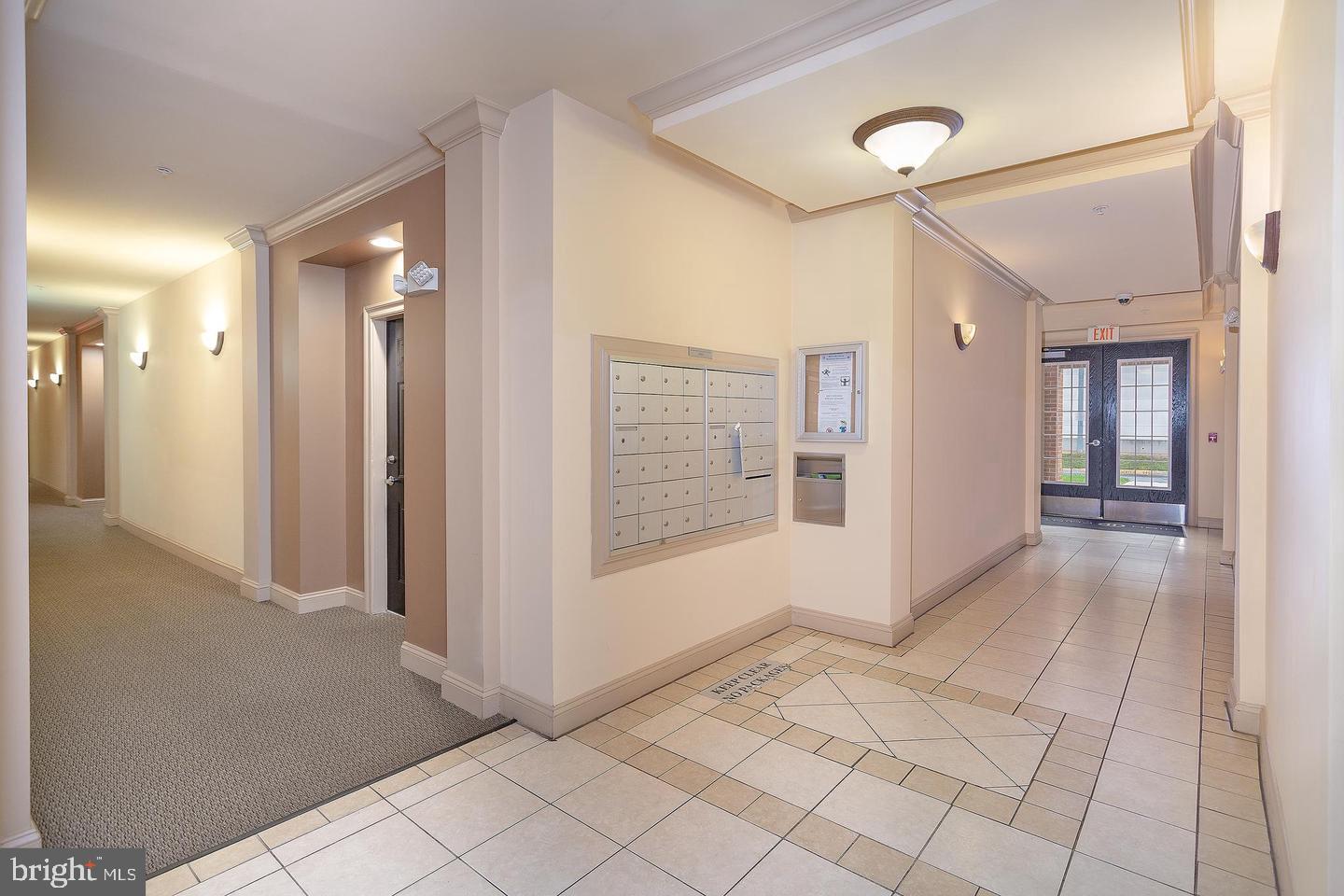 3009 Nicosh Circle, Unit 4302 Falls Church, VA 22042 - Photo 3 of 32 a view of a hallway with wooden floor and a living room