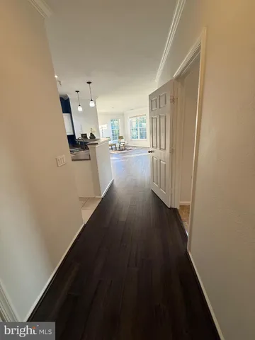 a view of a kitchen from a hallway