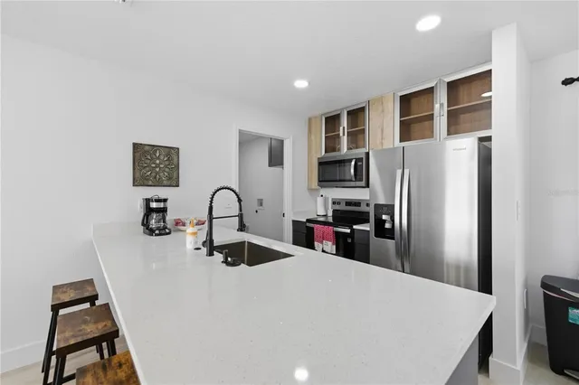 a kitchen with stainless steel appliances a refrigerator sink and stove
