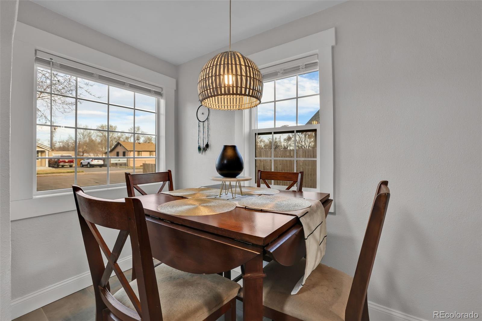 2411 Wyoming Avenue Pueblo, CO 81004 - Photo 11 of 25 a dining room with furniture a chandelier and wooden floor