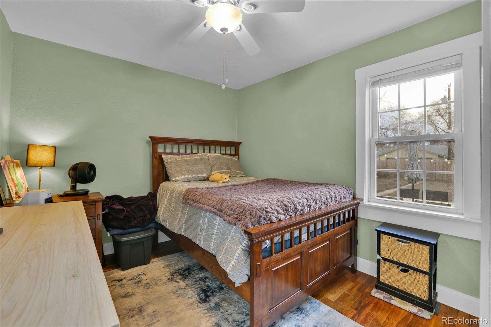 2411 Wyoming Avenue Pueblo, CO 81004 - Photo 13 of 25 a bedroom with a bed and wooden floor