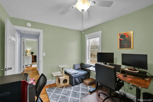 a view of a workspace with furniture and a window
