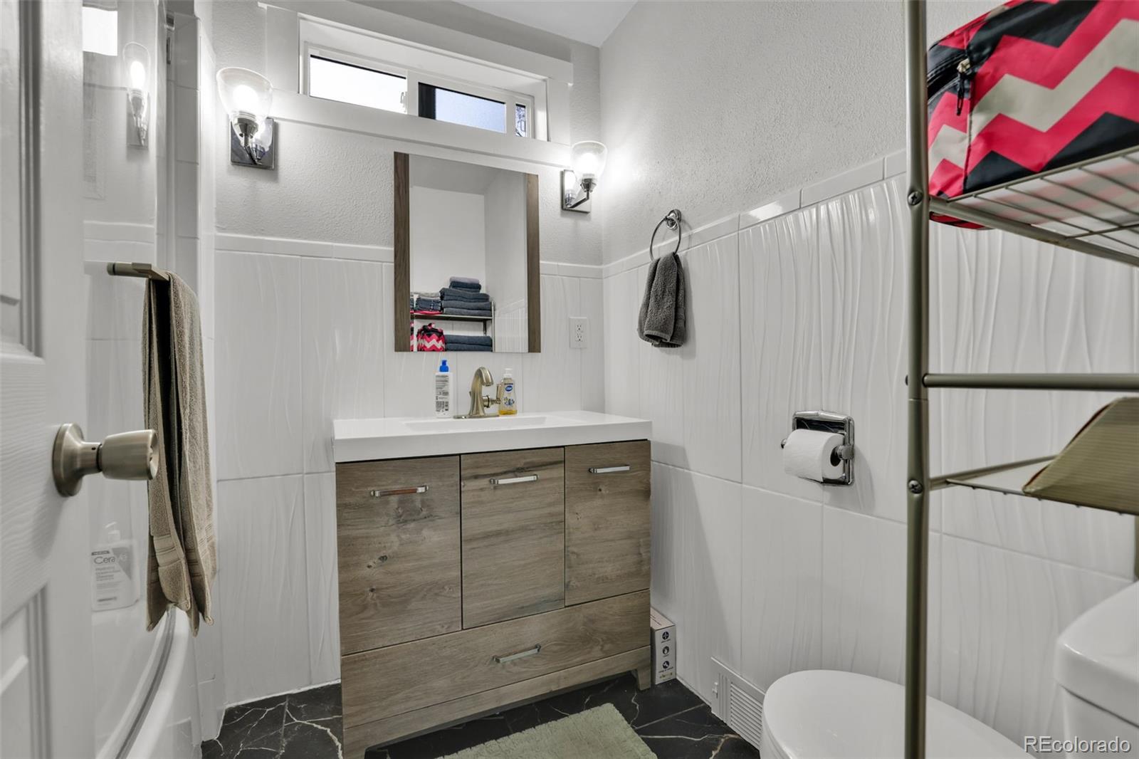 2411 Wyoming Avenue Pueblo, CO 81004 - Photo 17 of 25 a bathroom with a sink vanity mirror and toilet