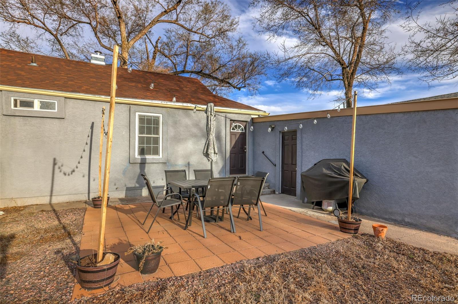 2411 Wyoming Avenue Pueblo, CO 81004 - Photo 19 of 25 a view of a patio with table and chairs and potted plants