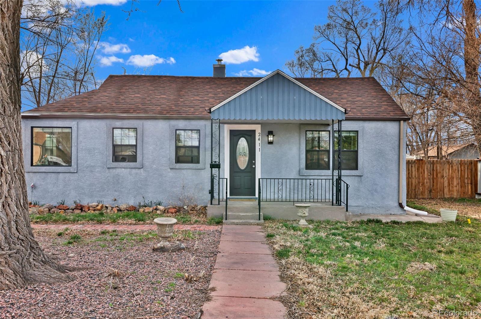 2411 Wyoming Avenue Pueblo, CO 81004 - Photo 3 of 25 a front view of a house with garden