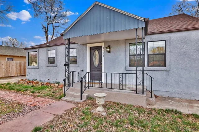 a front view of a house with a garden