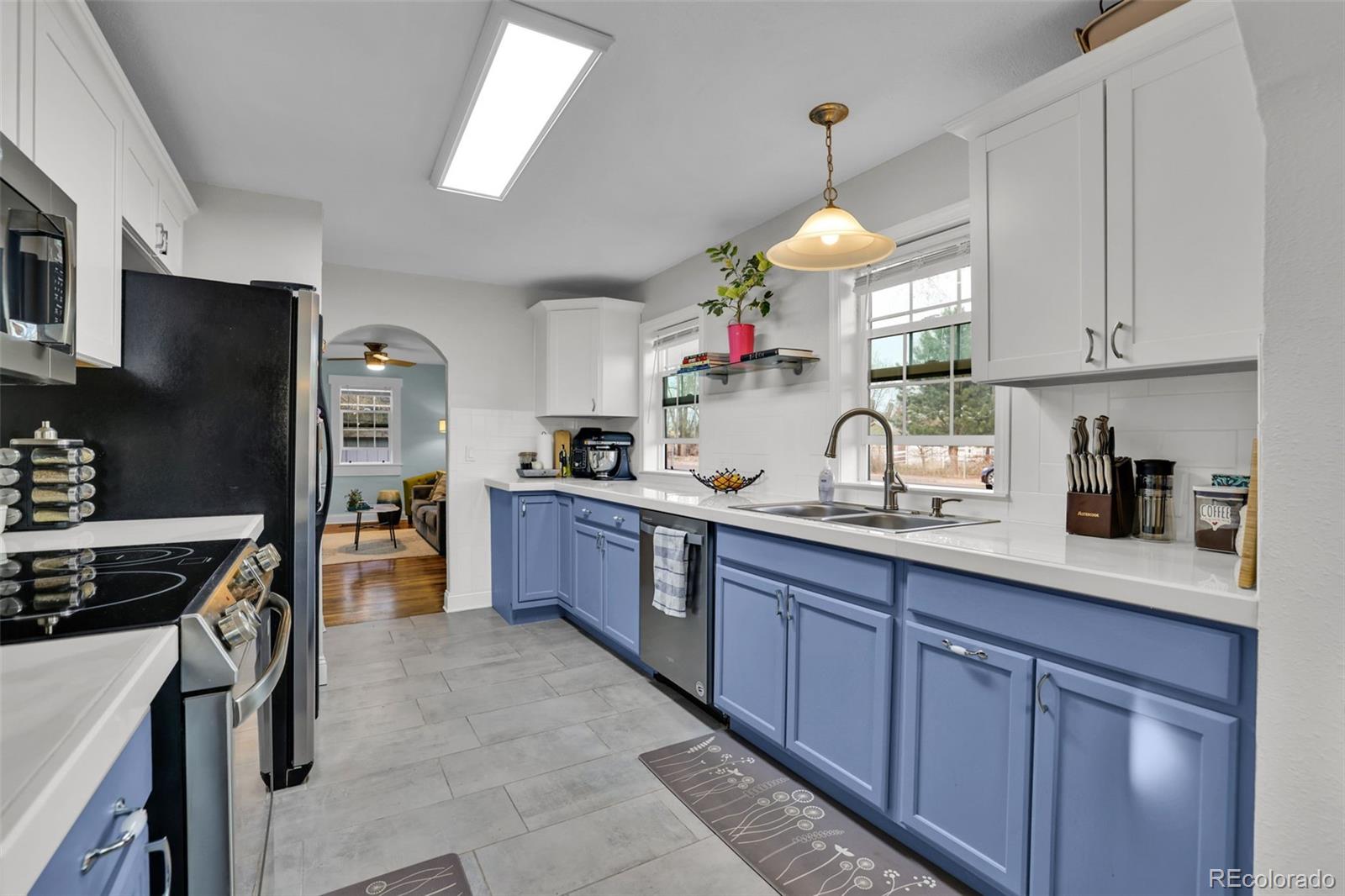 2411 Wyoming Avenue Pueblo, CO 81004 - Photo 10 of 25 a kitchen with granite countertop stainless steel appliances a sink dishwasher a refrigerator cabinets and a counter top space