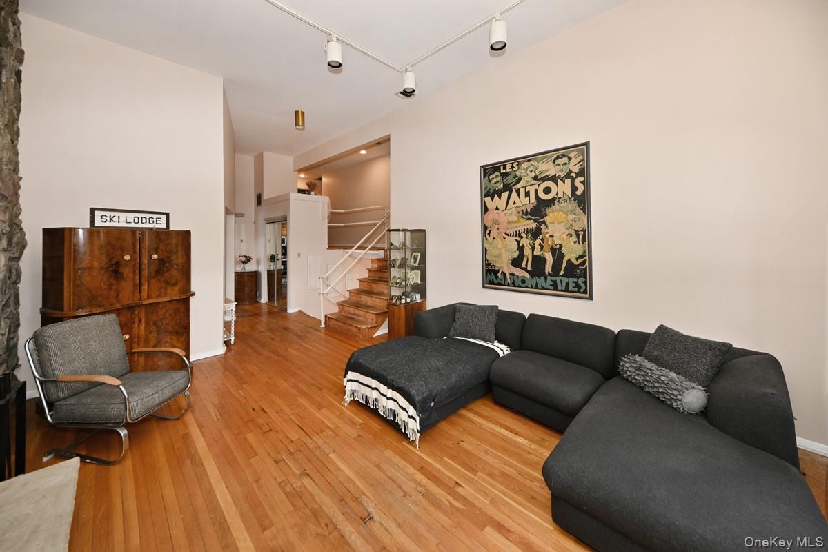 11 Lomond Avenue Chestnut Ridge, NY 10977 - Photo 14 of 26 Living room with light wood-type flooring, rail lighting, and stairs