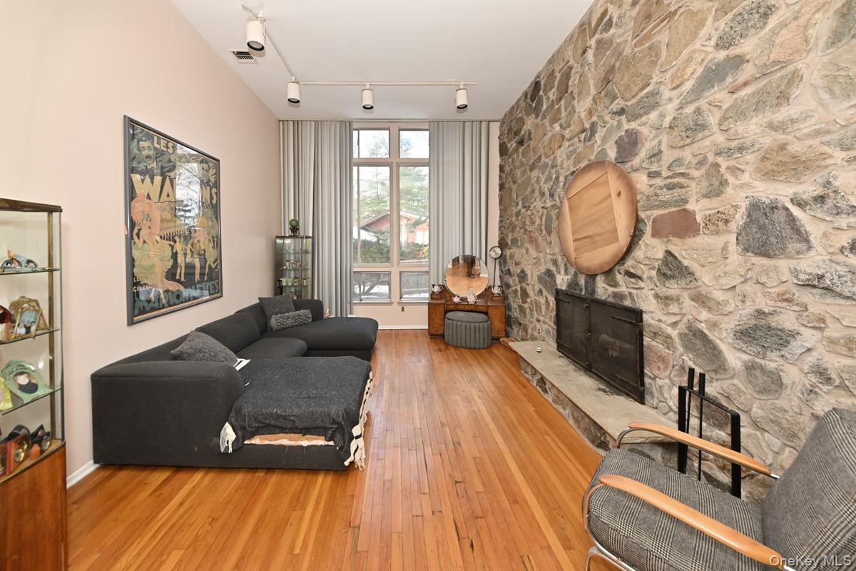 11 Lomond Avenue Chestnut Ridge, NY 10977 - Photo 4 of 26 Living area featuring light wood finished floors, a stone fireplace, and rail lighting