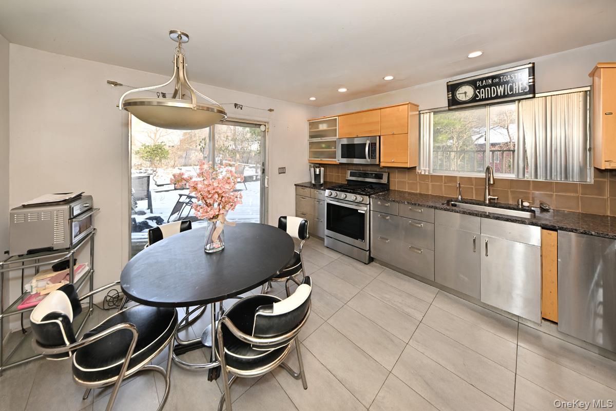 11 Lomond Avenue Chestnut Ridge, NY 10977 - Photo 10 of 26 Kitchen with tasteful backsplash, stainless steel appliances, hanging light fixtures, dark stone counters, and recessed lighting