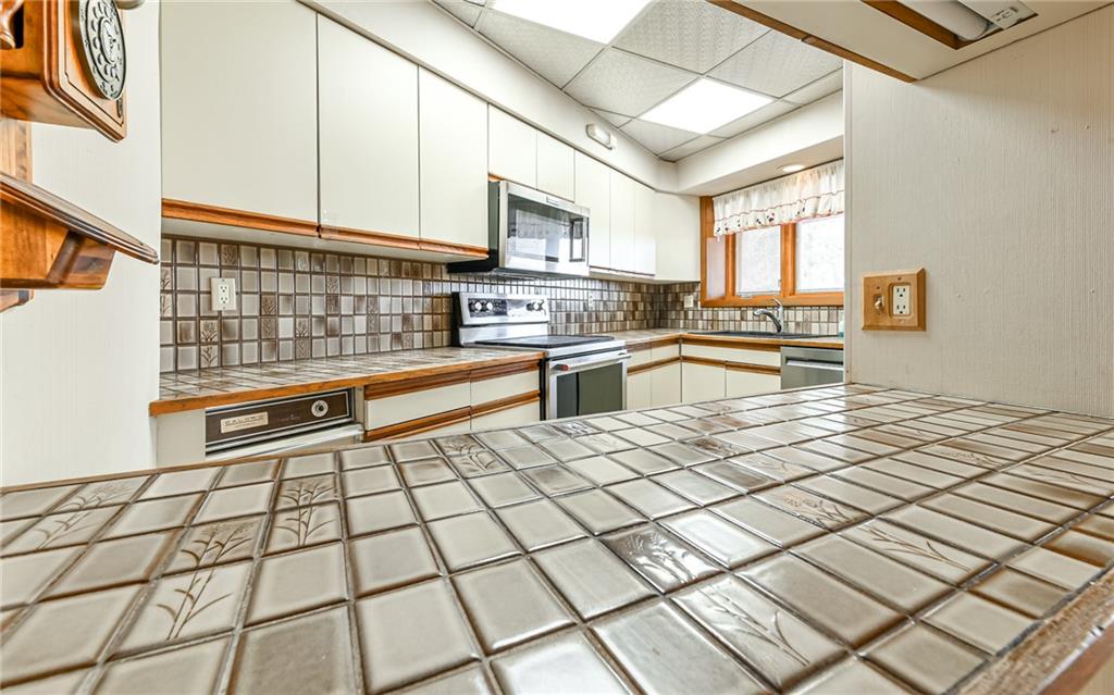 3656 Graham School Road Cranberry Township, PA 16066 - Photo 11 of 28 a kitchen with stainless steel appliances cabinets and a stove top oven