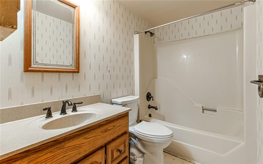 3656 Graham School Road Cranberry Township, PA 16066 - Photo 17 of 28 a bathroom with a sink a toilet and shower