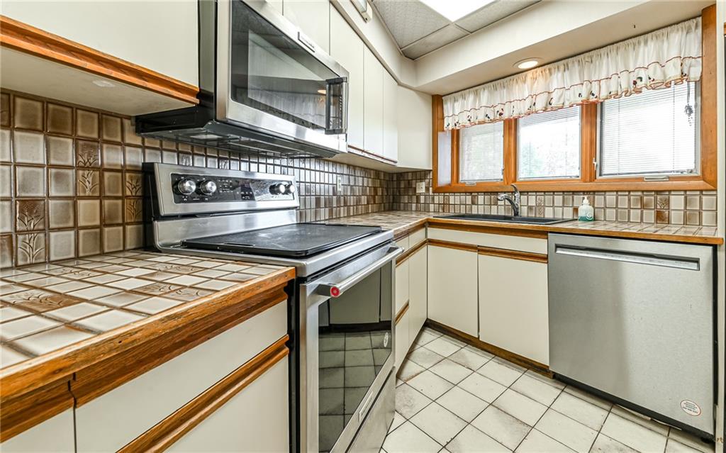 3656 Graham School Road Cranberry Township, PA 16066 - Photo 10 of 28 a kitchen with a stove and a sink