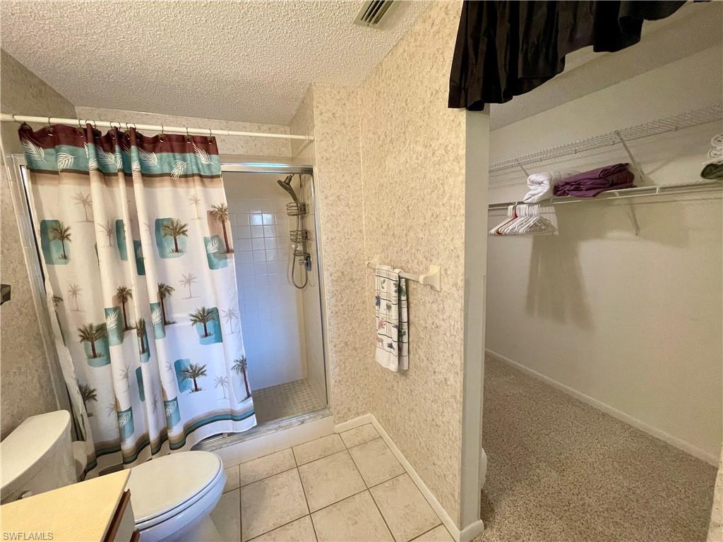 256 Pebble Beach Circle, Unit D201 Naples, FL 34113 - Photo 13 of 19 a bathroom with a shower and toilet