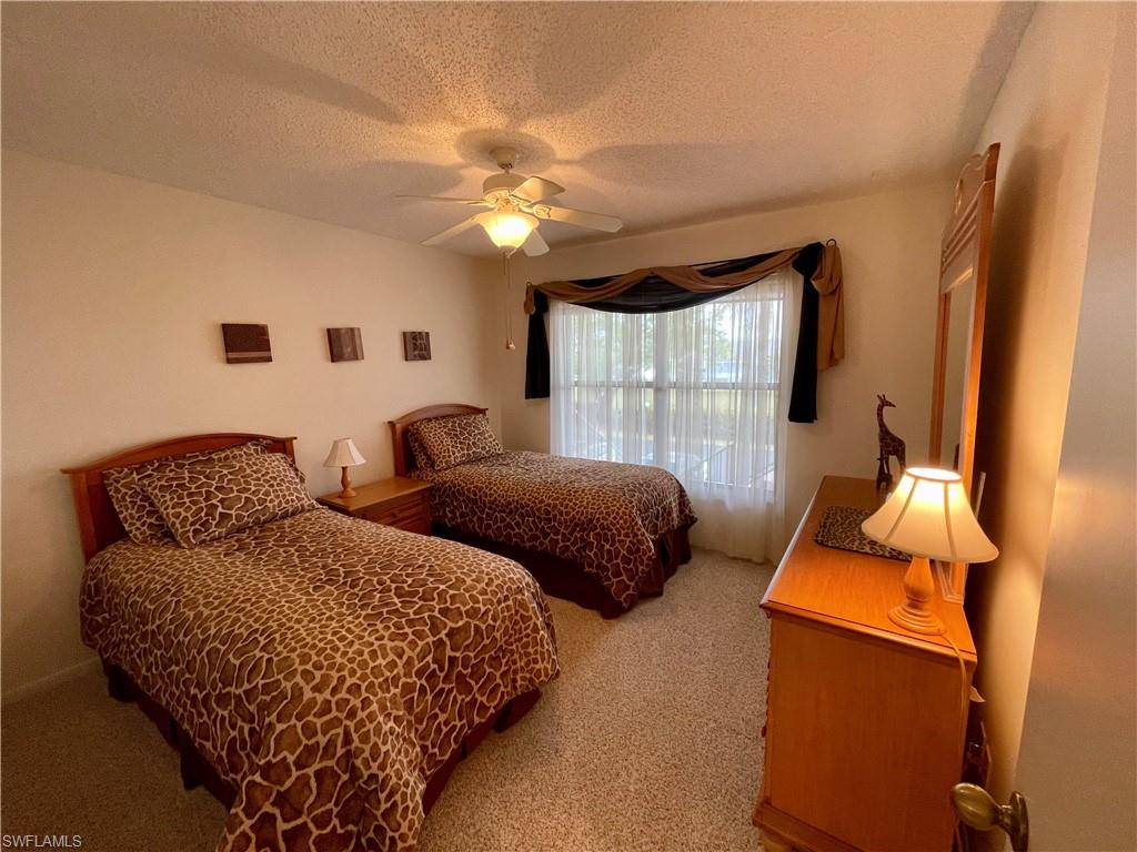 256 Pebble Beach Circle, Unit D201 Naples, FL 34113 - Photo 14 of 19 a bedroom with two beds and a window
