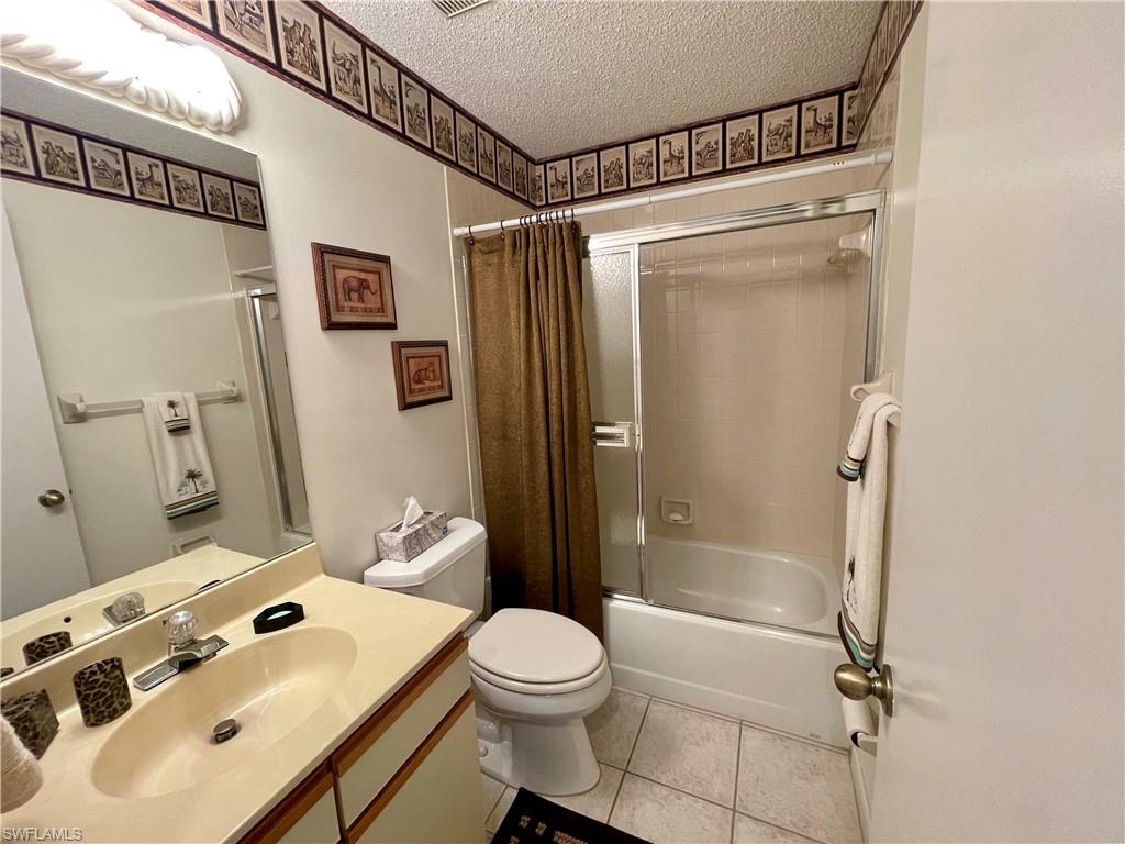 256 Pebble Beach Circle, Unit D201 Naples, FL 34113 - Photo 15 of 19 a bathroom with a sink toilet and shower