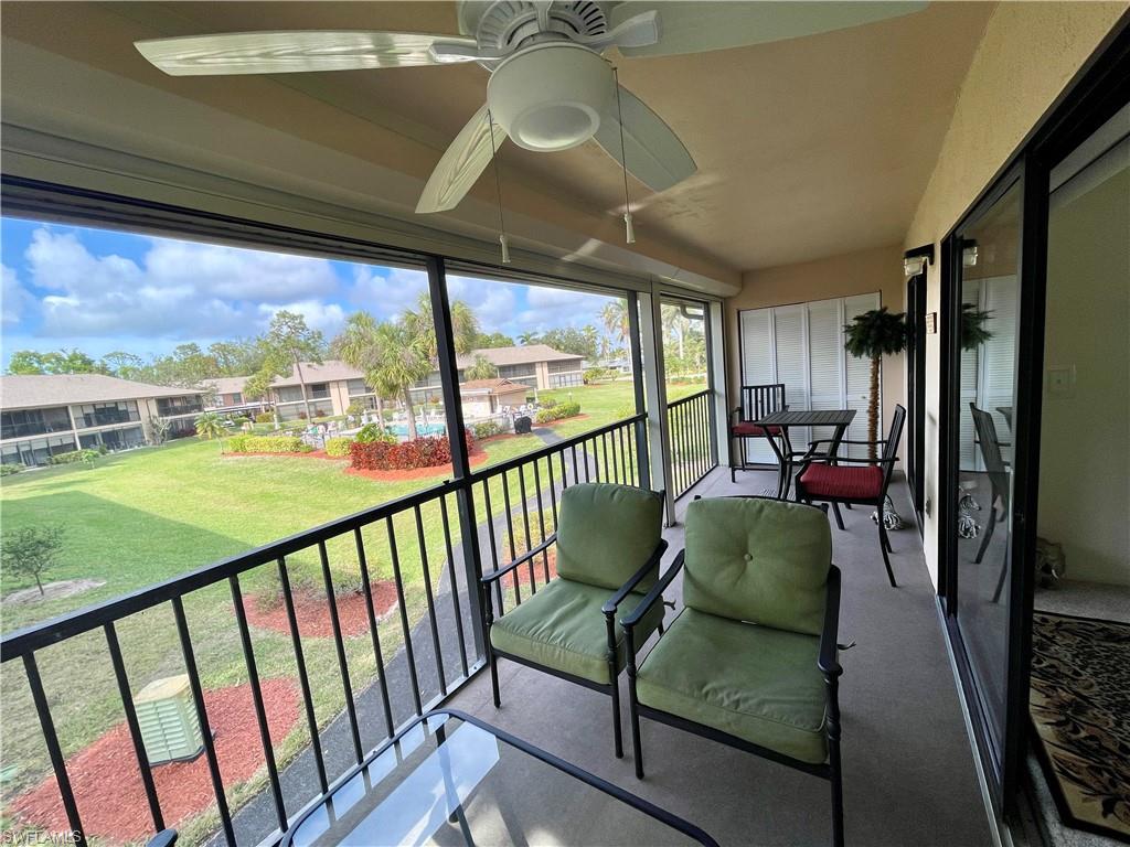 256 Pebble Beach Circle, Unit D201 Naples, FL 34113 - Photo 17 of 19 a view of a porch with furniture and a yard