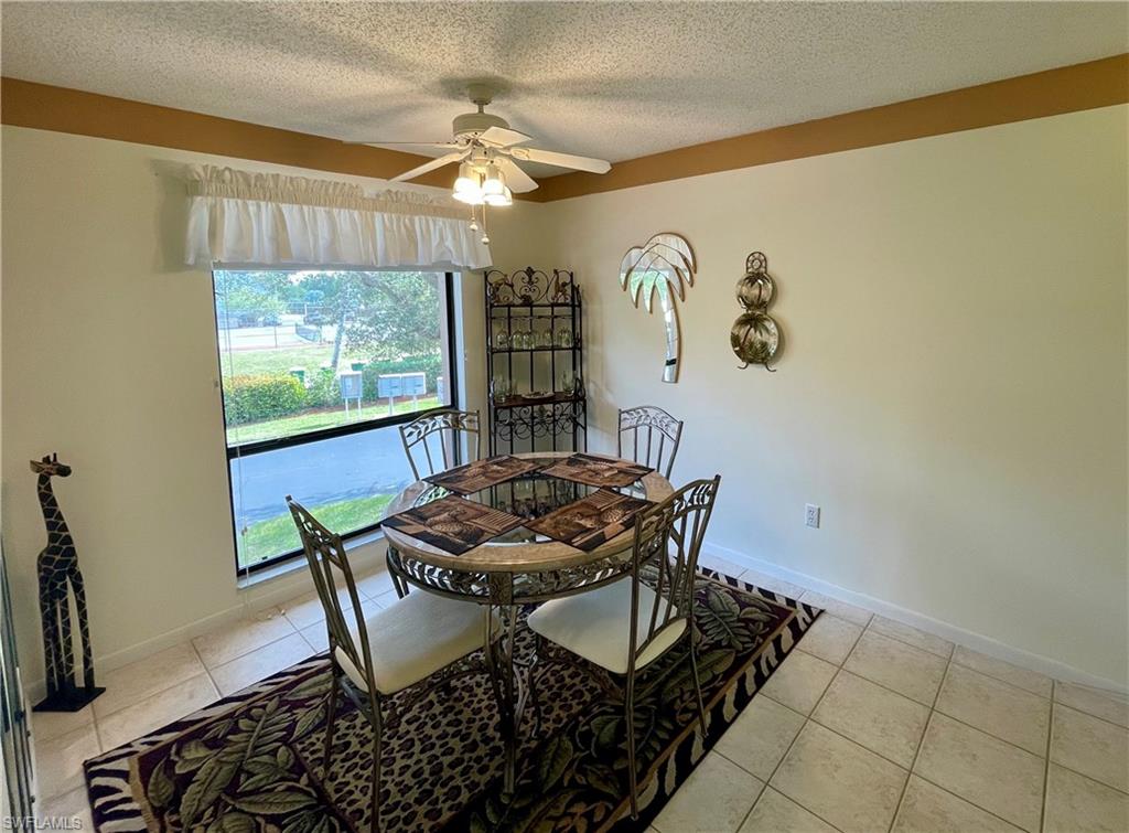 256 Pebble Beach Circle, Unit D201 Naples, FL 34113 - Photo 2 of 19 a dining room with furniture and window