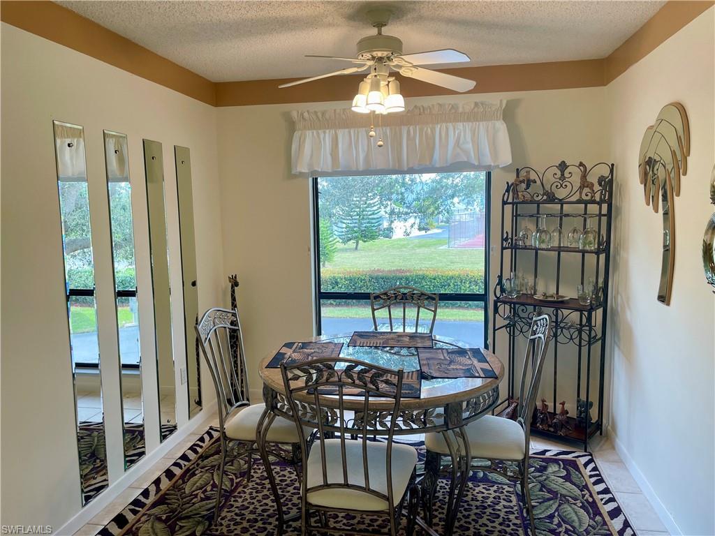 256 Pebble Beach Circle, Unit D201 Naples, FL 34113 - Photo 3 of 19 a view of a dining room with furniture window and outside view