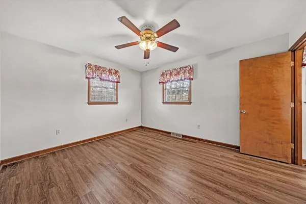wooden floor in an empty room with a window