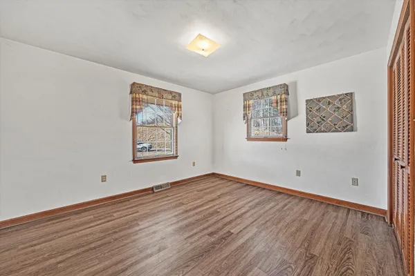 a view of a wooden deck with trees
