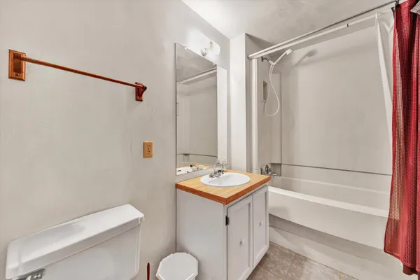 a kitchen with granite countertop cabinets stainless steel appliances and chairs